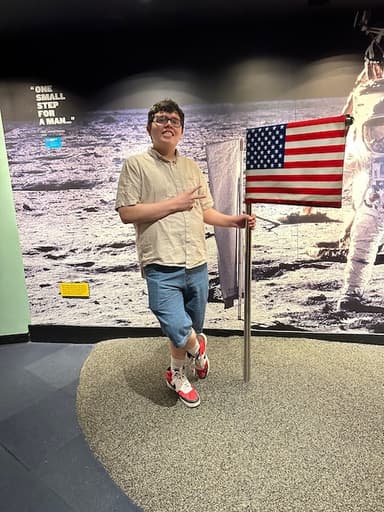 Me next to a US flag at the Chicago Planetarium